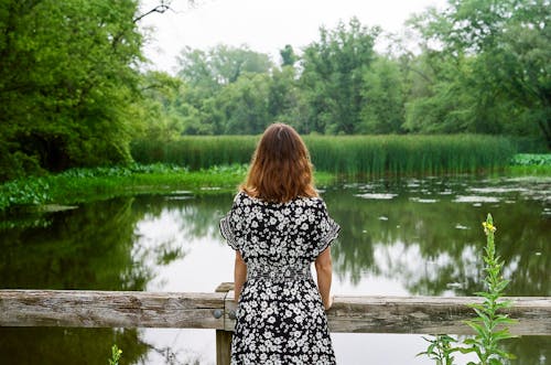 Woman in Sundress Standing near Pond in Park