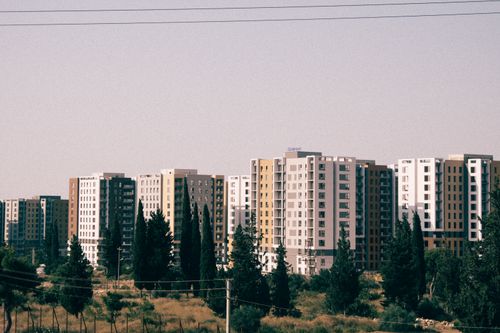 Free Urban residential buildings with trees and clear sky in Tbilisi. Stock Photo