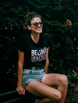 Young woman enjoying a sunny day sitting on a bench in Genoa, Italy.