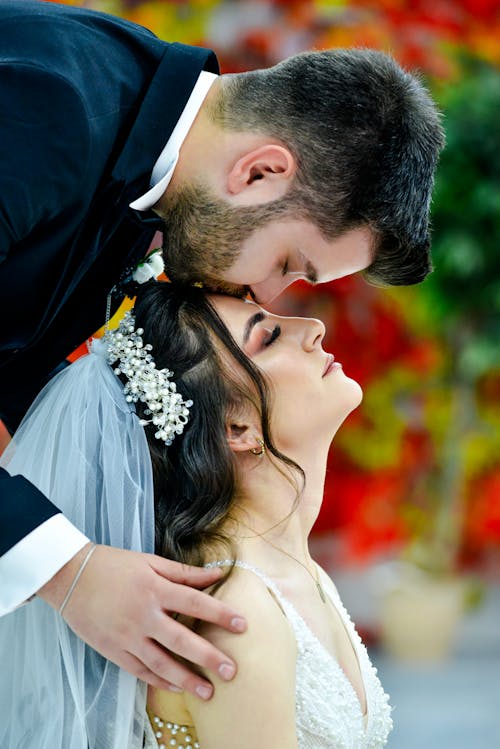 Groom Kissing the Bride on the Forehead