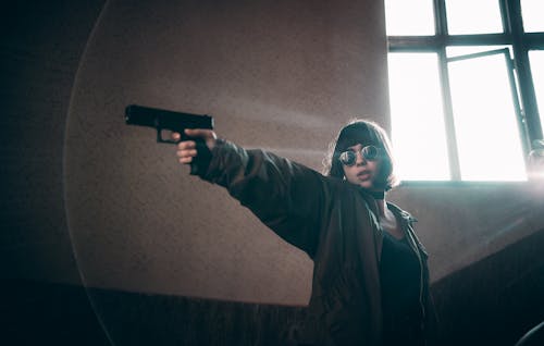 Teenage Girl Holding a Gun