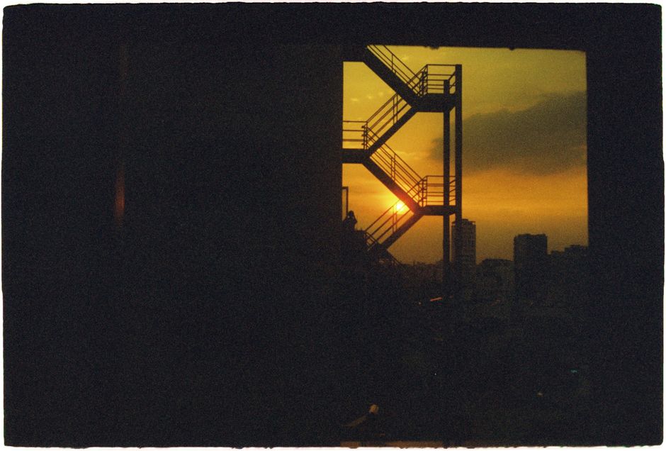 Silhouette of a staircase with cityscape at sunset, offering a captivating urban scene.
