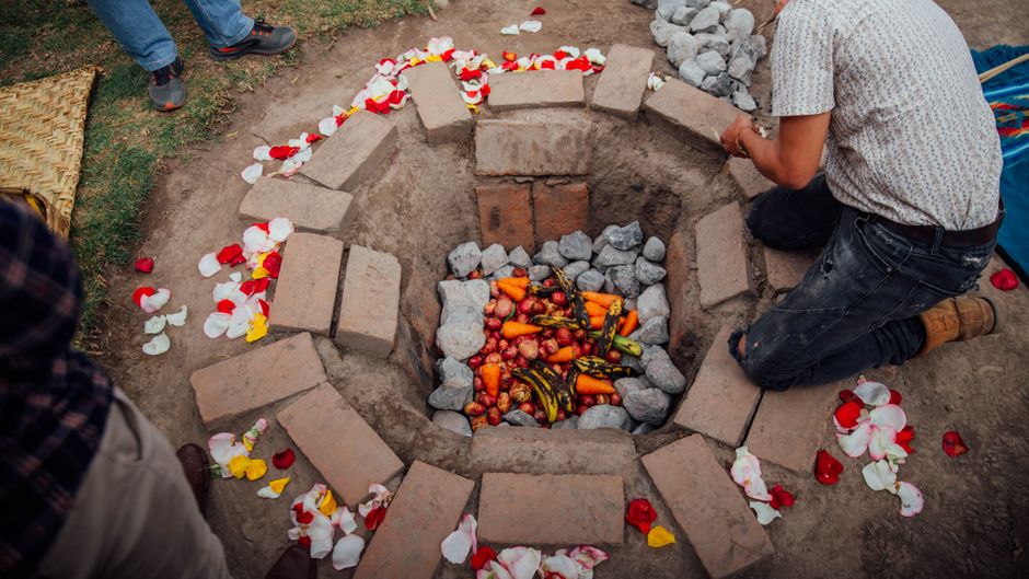 Photo by Daky Imbaquingo on Pexels Traditional underground oven in Otavalo, Ecuador with vegetables and petals.
