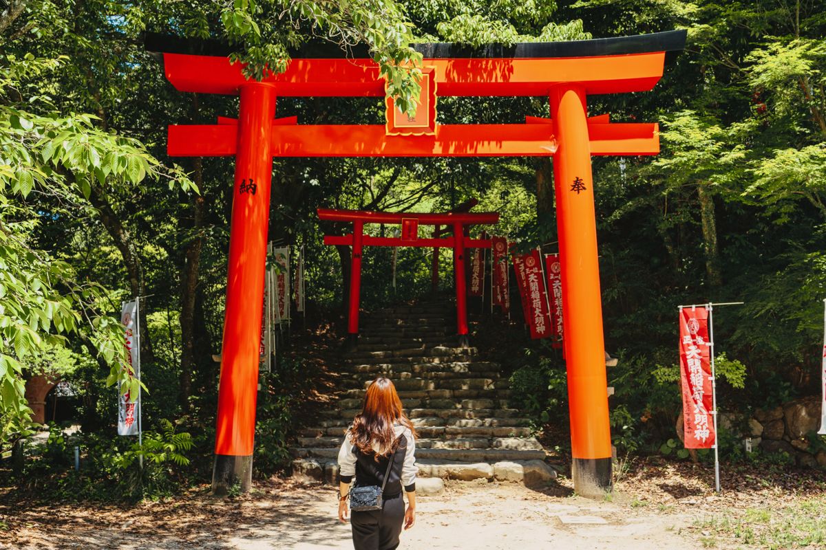 Woman traveller with backpack at a scenic Japanese temple