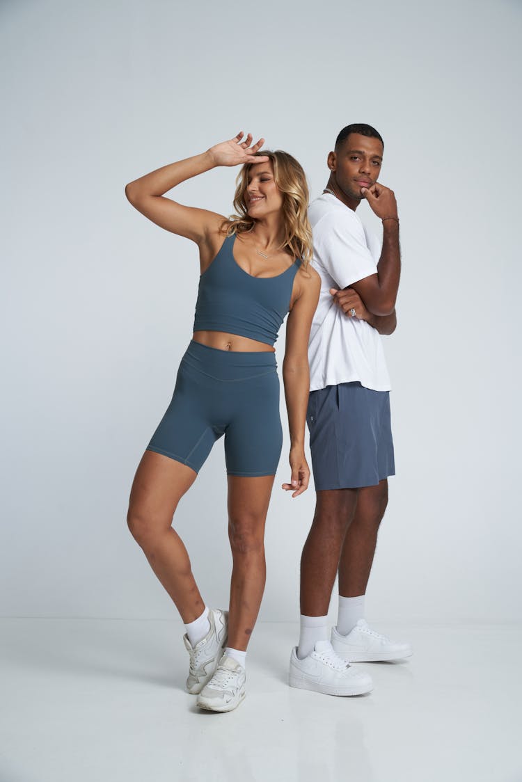 Woman And Man Posing In Gym Clothing