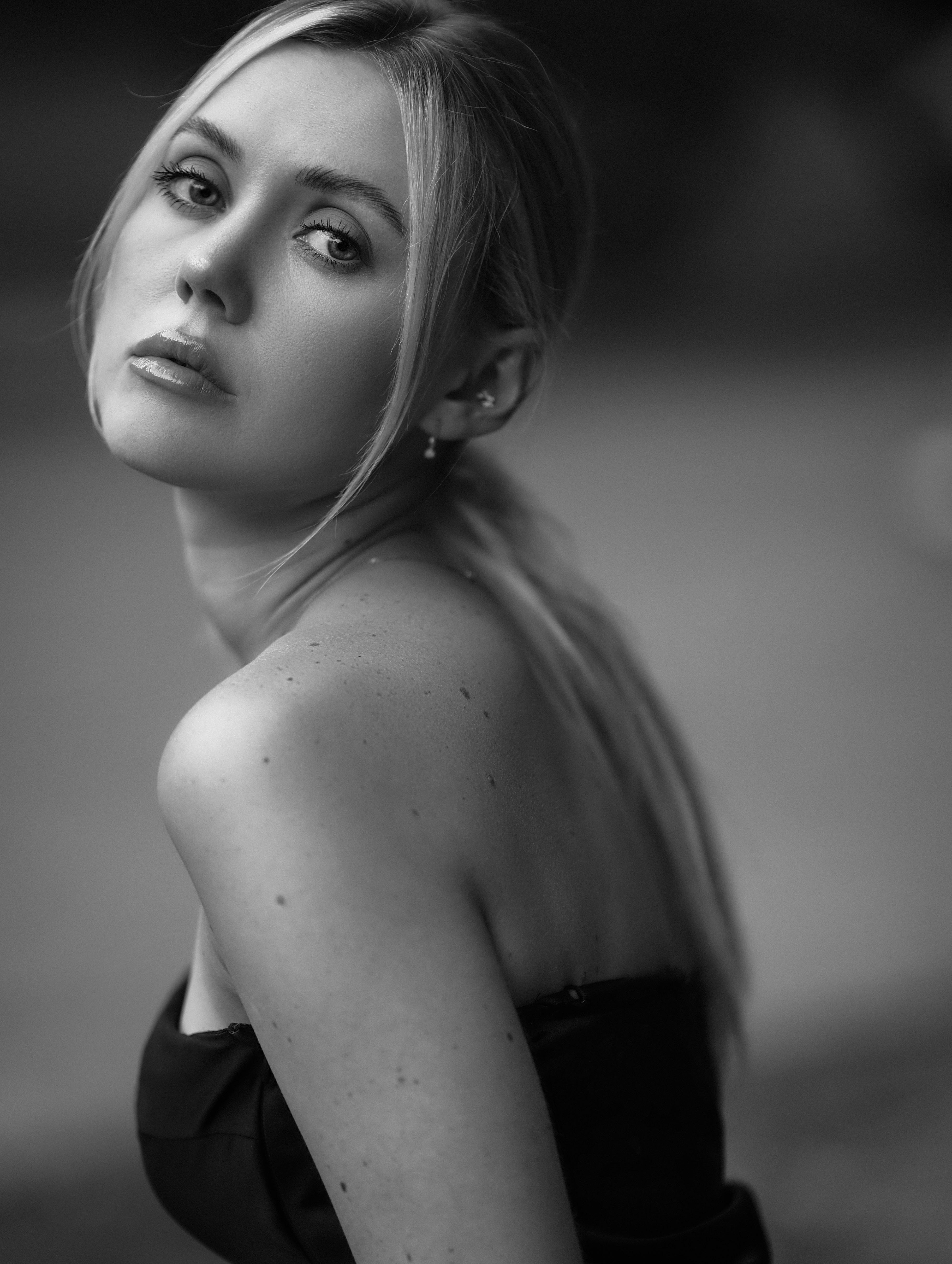 Black and white portrait capturing an elegant woman with long blonde hair and expressive eyes.