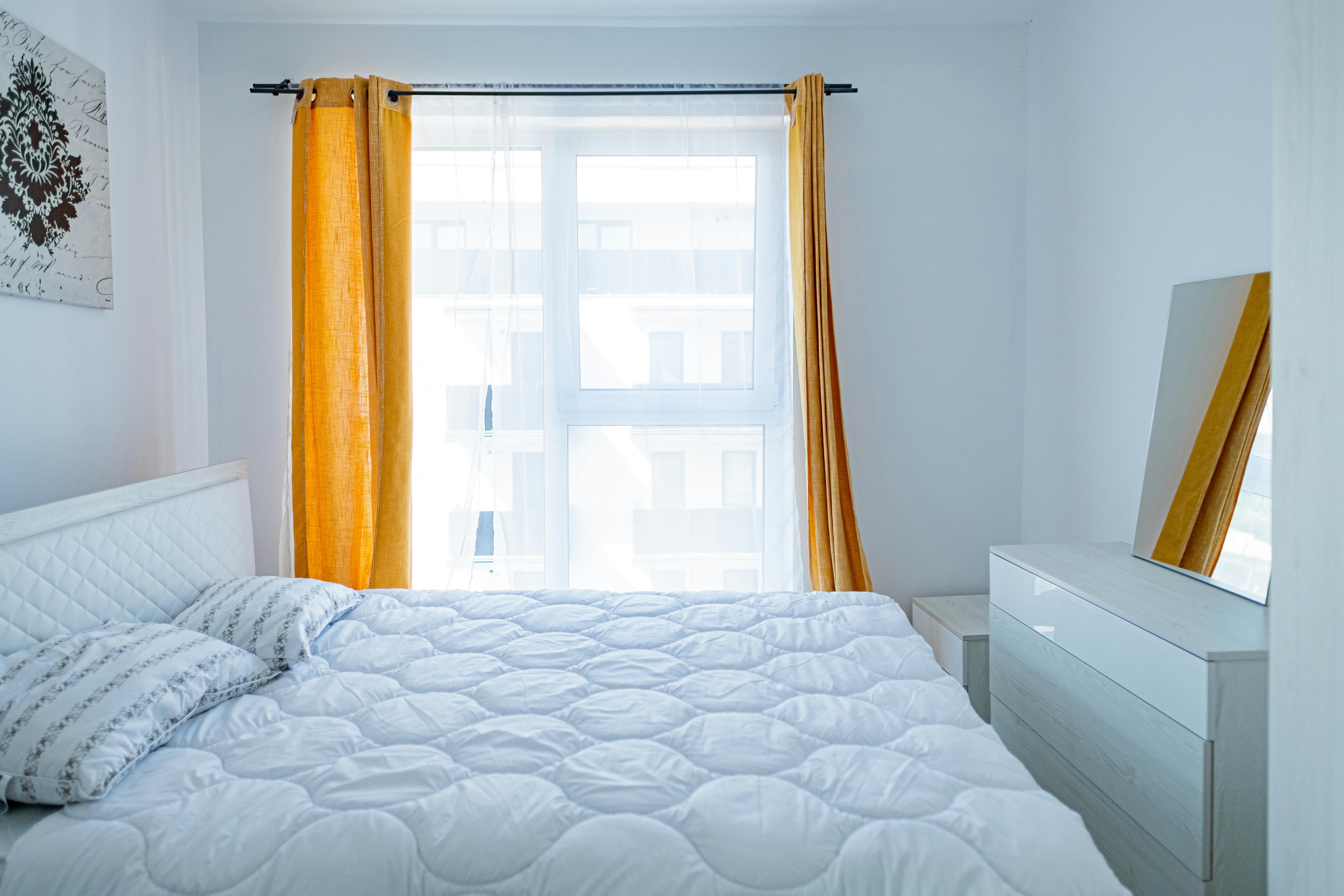 yellow curtains in white bedroom