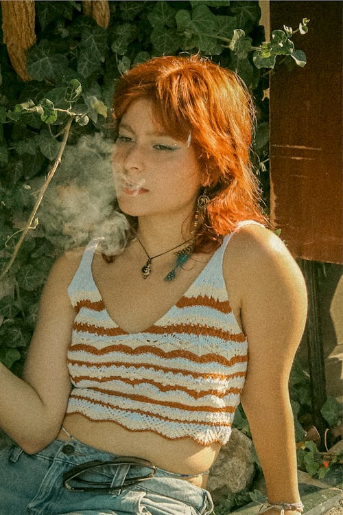 Woman Smoking a Cigarette in a Garden