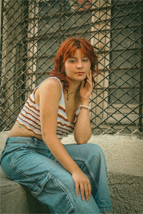 Young Woman in a Summer Outfit Sitting Outside 