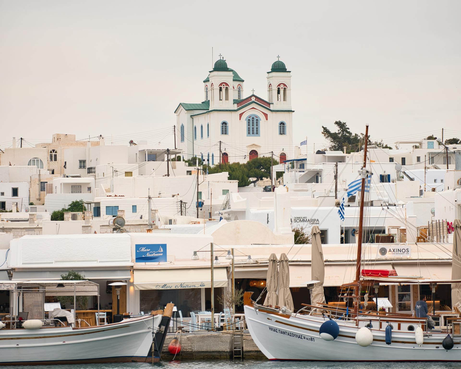 Explore the charming port and traditional Greek architecture in Naousa, Paros Island.