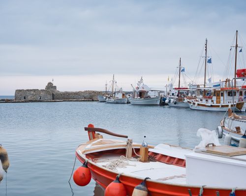 Free Peaceful harbor scene with moored boats in Naousa, Greece against a calm sea backdrop. Stock Photo