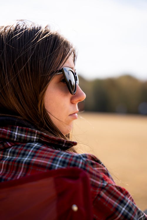 Woman in Sunglasses and Checked Blouse