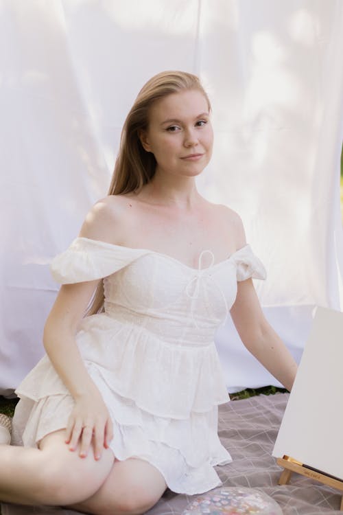 Blonde Woman Posing in White Ruffled Dress