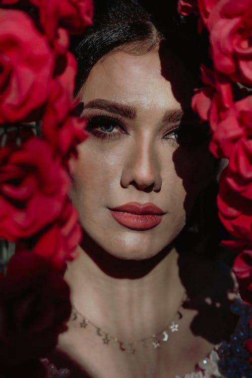 Portrait of Woman Among Red Roses