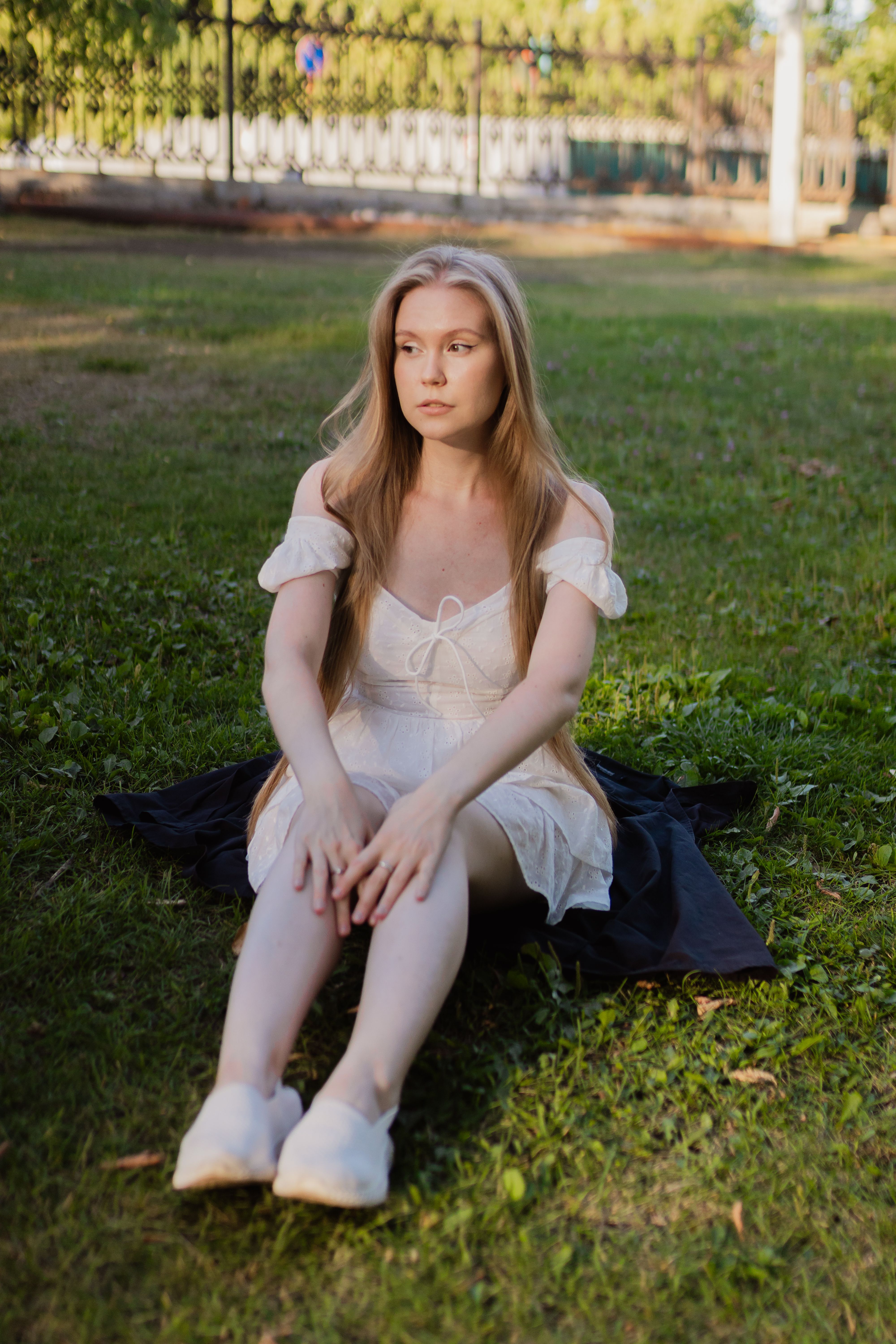 Blonde Woman in White Dress Sitting in a Park · Free Stock Photo