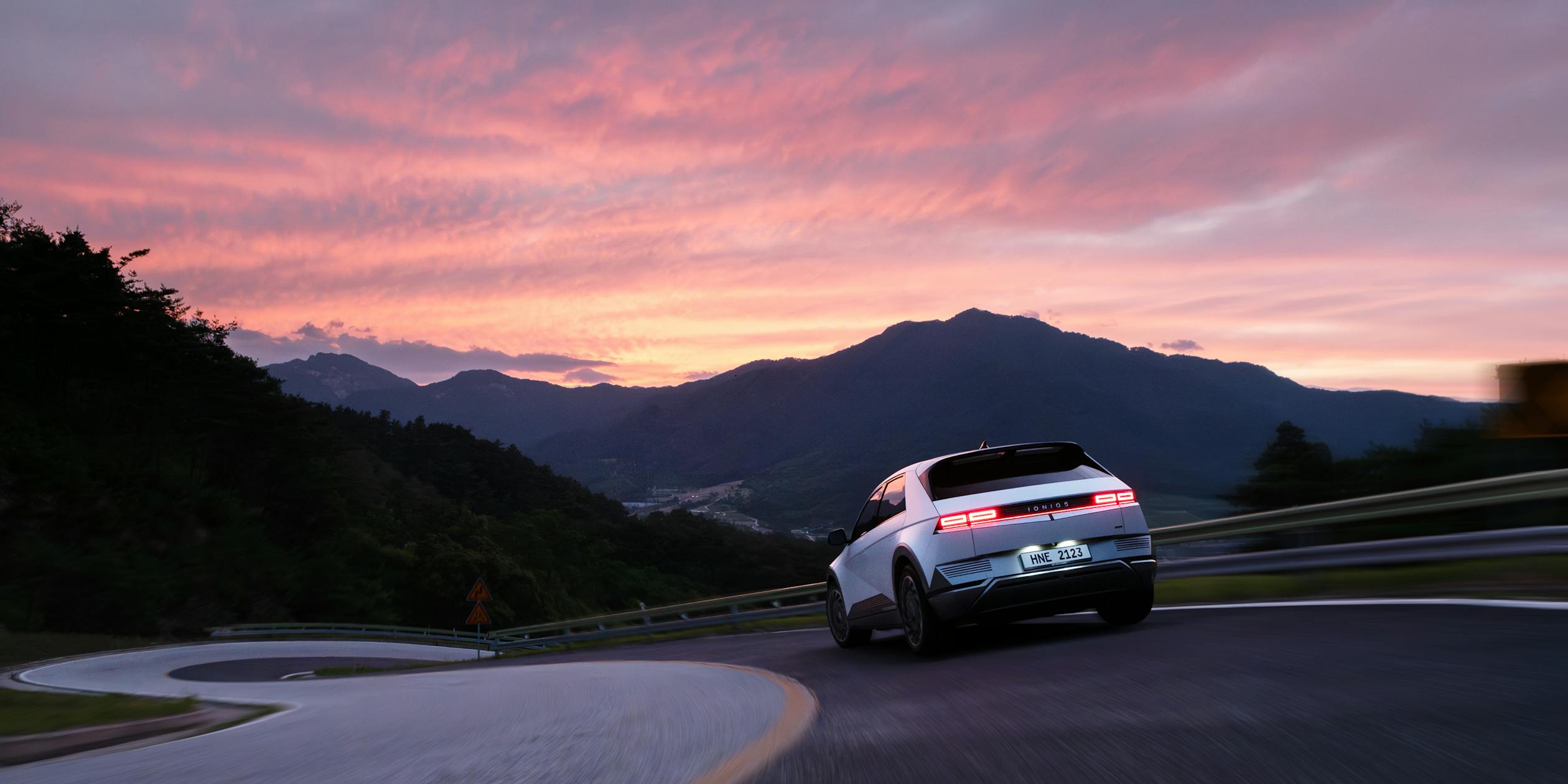 Hyundai Ioniq 5 Driving at Sunset in Mountainous Landscape