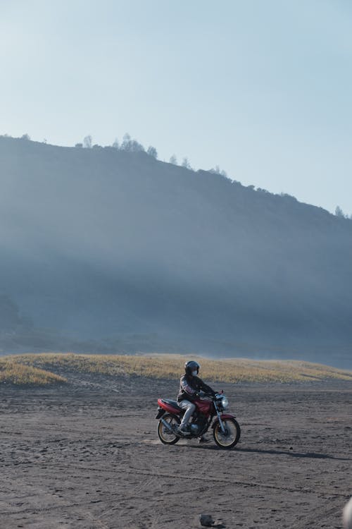 Cyclist on a Dirt Road, and a Hill in Mist