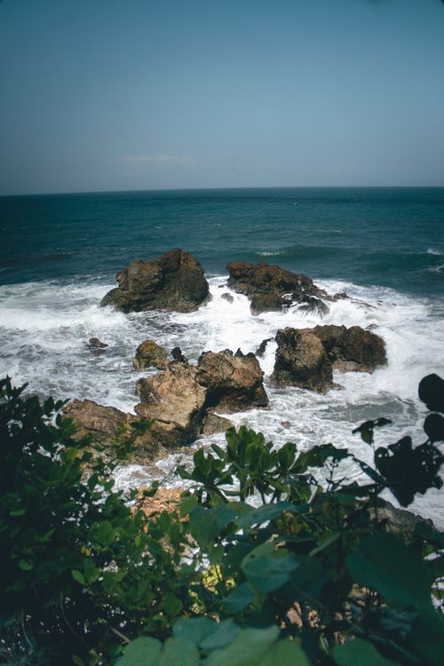 Free Captivating ocean view with rocky shoreline and lush greenery in Tasikmalaya, West Java. Stock Photo