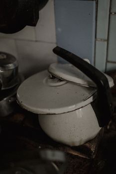 An atmospheric shot of a vintage enamel teapot in a rustic kitchen, exuding nostalgia and warmth.