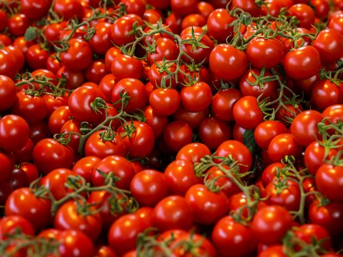 Free A vibrant collection of fresh organic cherry tomatoes on display at a market. Stock Photo