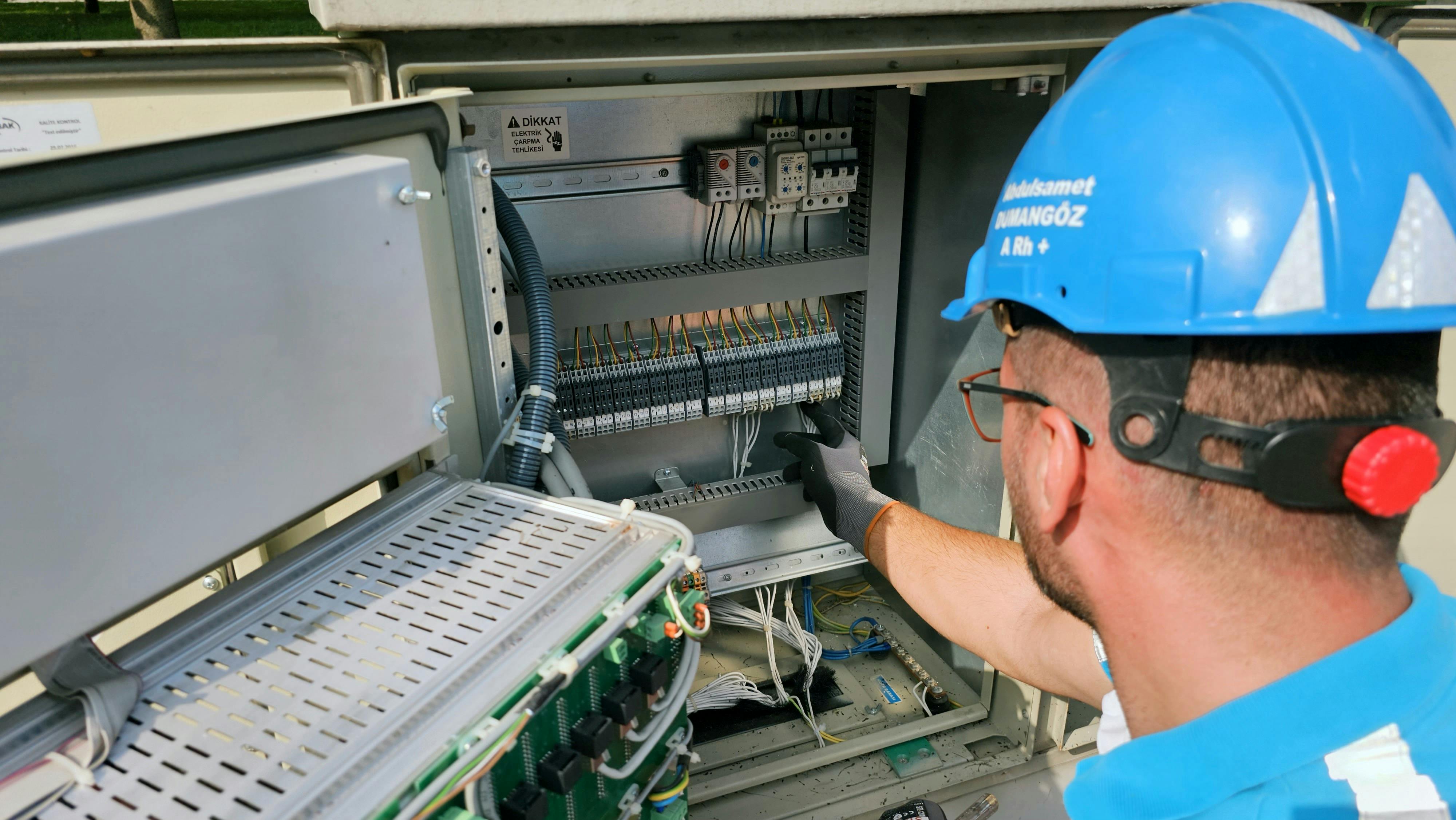 Image Name electrician installing a surge protector in the fusebox
