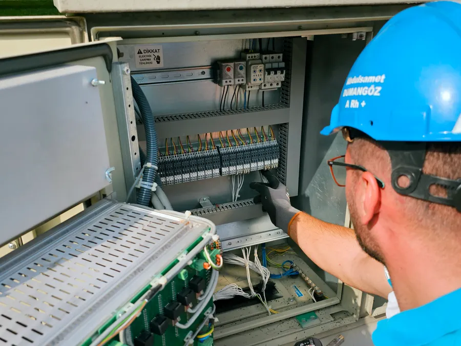 Electrician working on a power distribution box