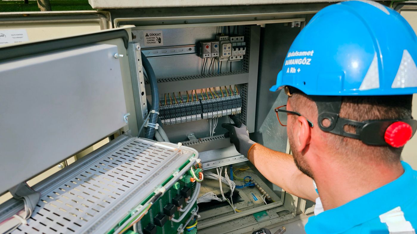 Electrician inspecting an electrical panel