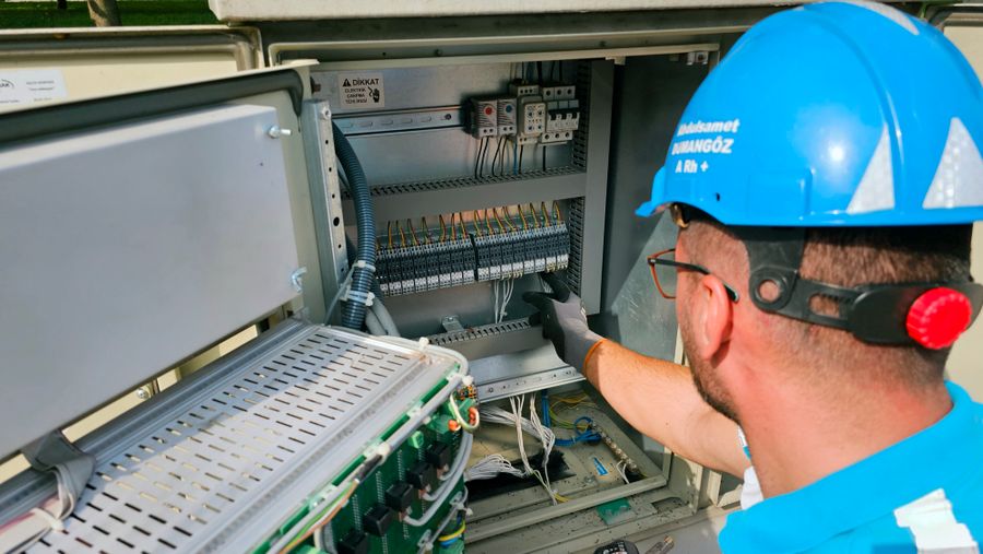 Electrician working on an electrical panel