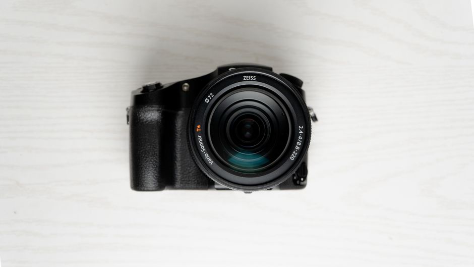 High-quality image of a DSLR camera lens from above on a white surface.