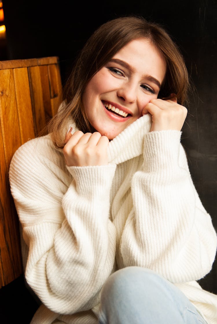 Brunette Woman Posing In White Turtleneck Sweater