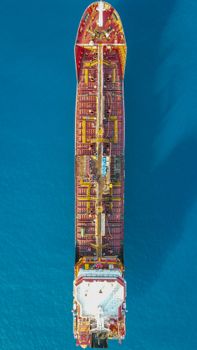 Top-down view of a cargo ship sailing in the clear blue waters near Kaş, Antalya, Türkiye.