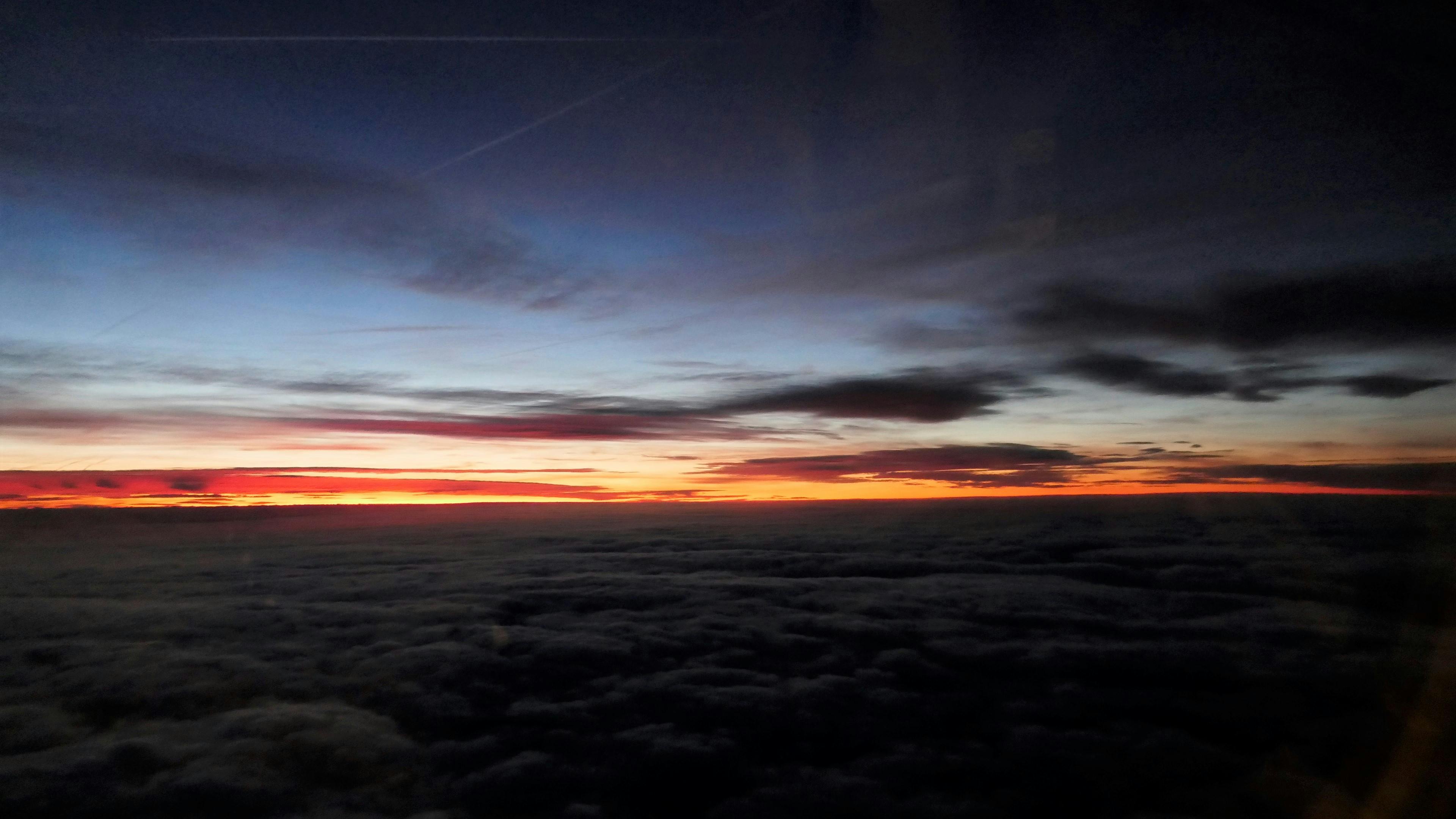 Free stock photo of airplane view, gold light to darkness, Sunset over the clouds