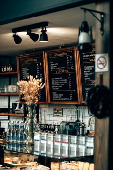 Warm café ambiance with espresso bar and menu boards in Baku, Azerbaijan.