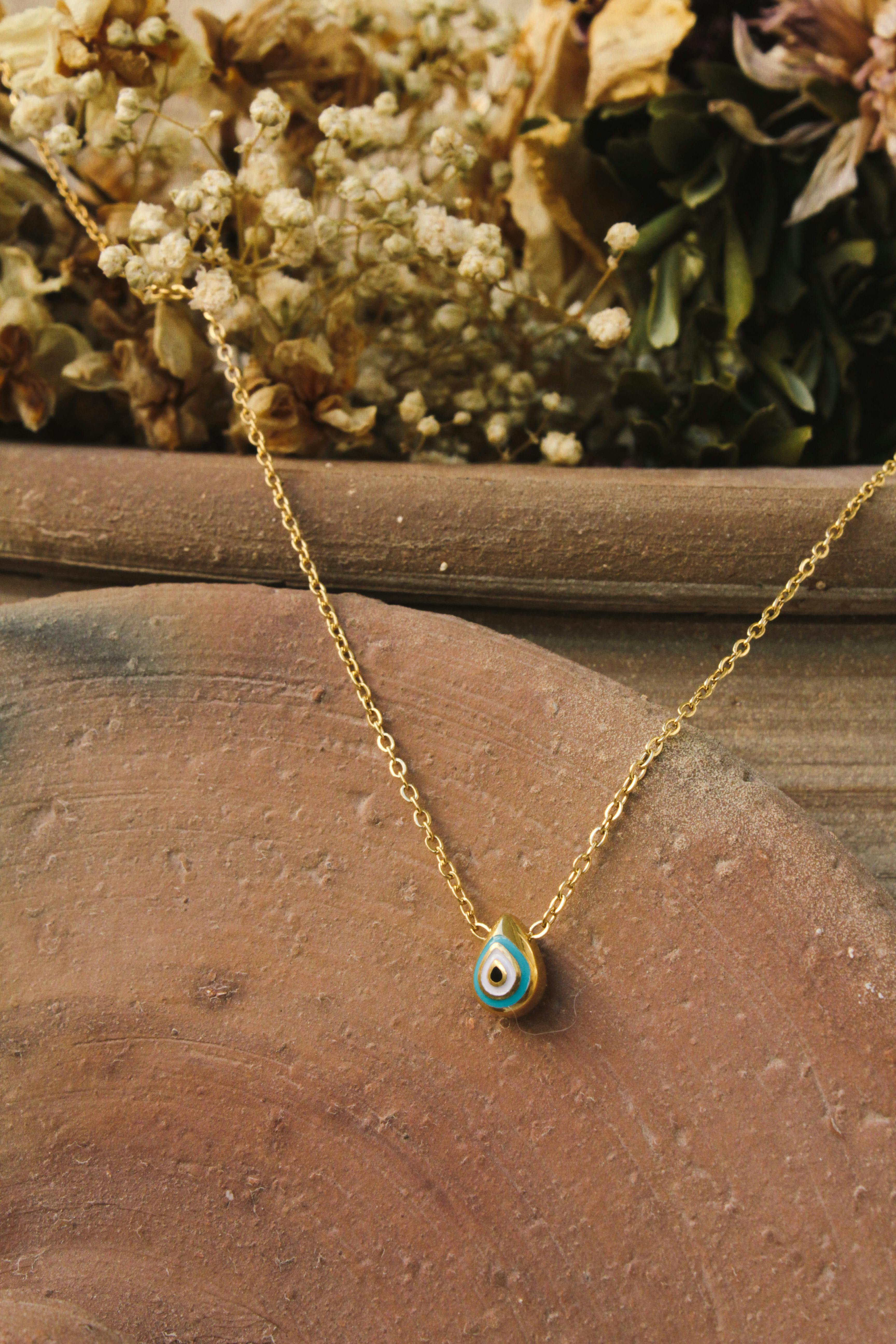 Gold Chain with Evil Eye Bead · Free Stock Photo