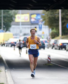 Marathon runner in yellow tank top jogging on city street under bridge, vibrant day.