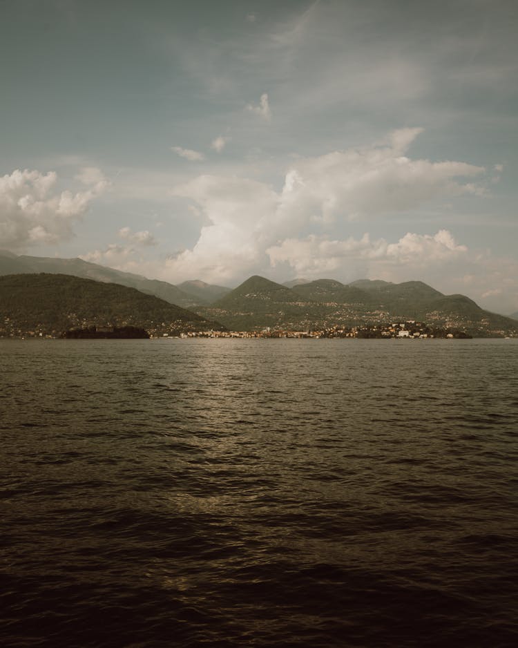 Calm Sea Coast With Town Behind