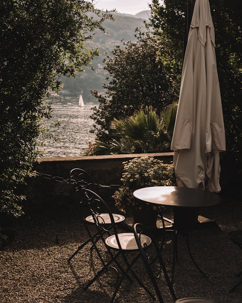 Umbrella and Furniture on a Terrace by the Lake 