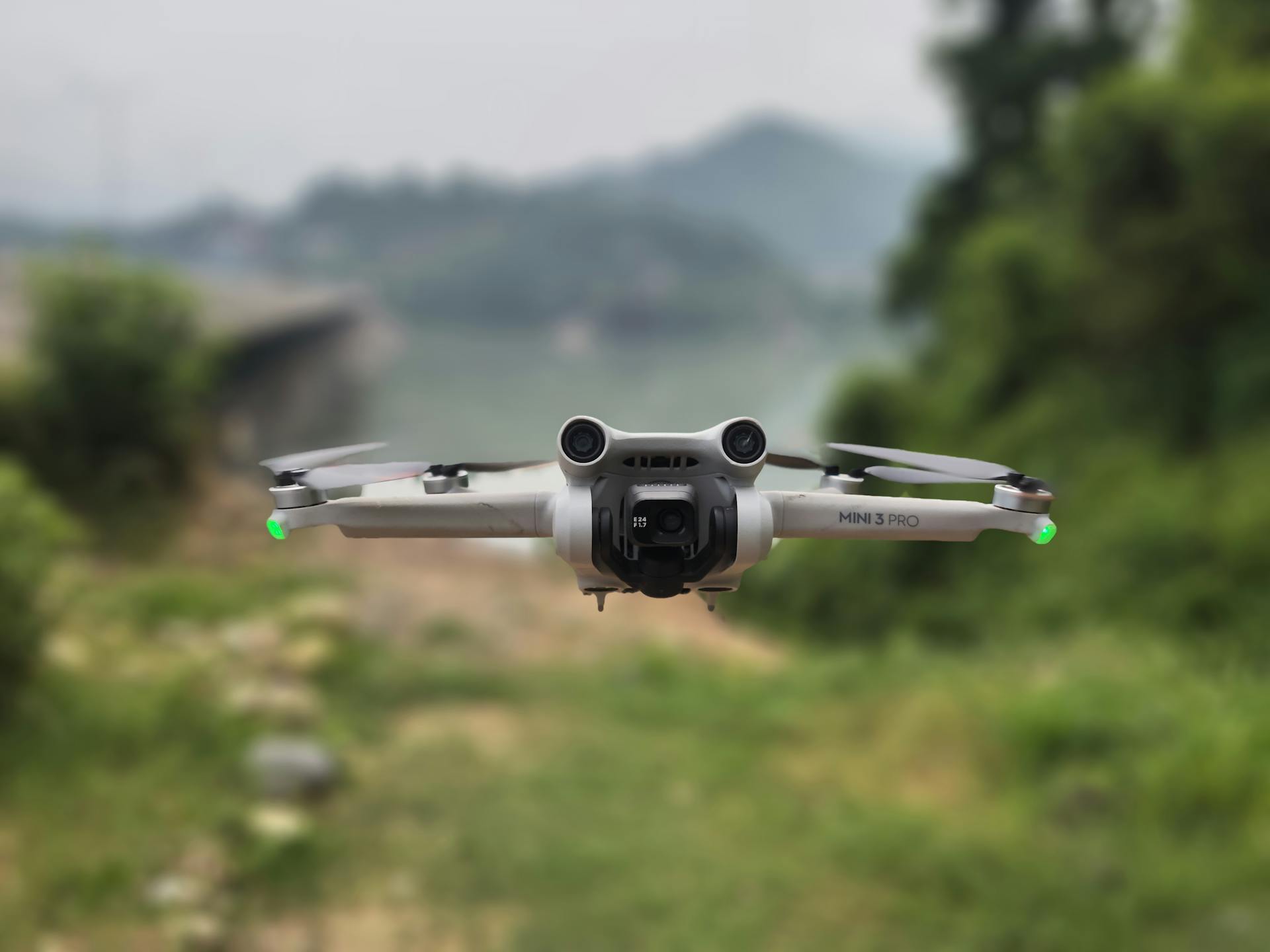 A drone in flight over a forest landscape in Bilaspur, India.