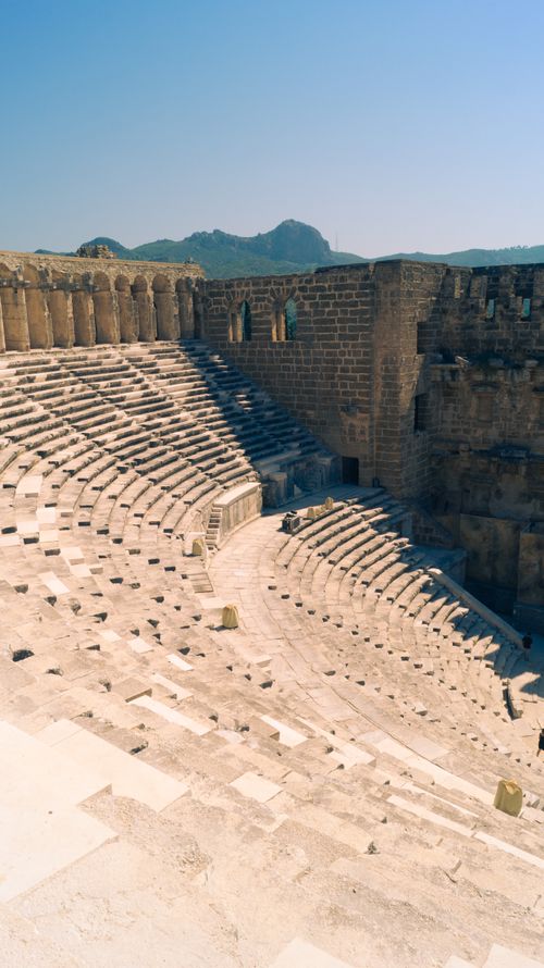 Free Explore the grandeur of an ancient Roman amphitheater under a clear blue sky. Stock Photo