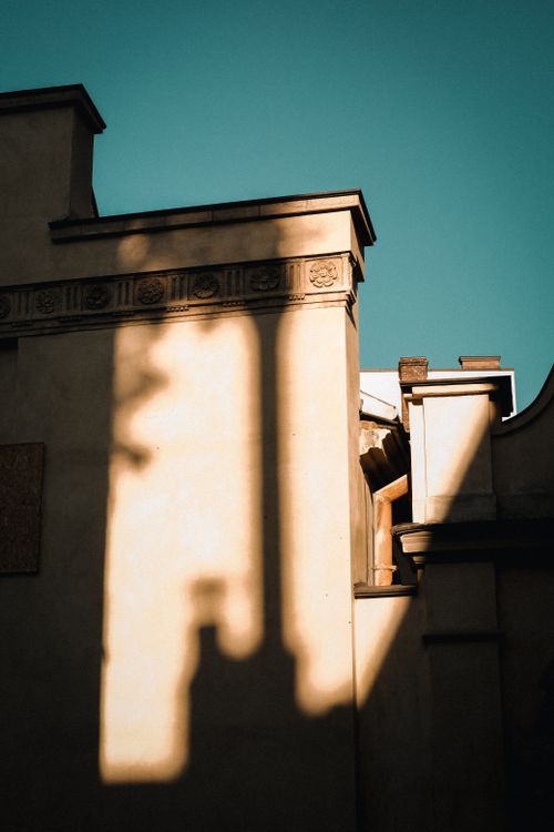 Free A striking view of urban architecture with dramatic shadows and a clear sky. Stock Photo