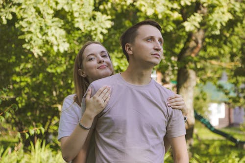 Young Woman Embracing a Man in a Park