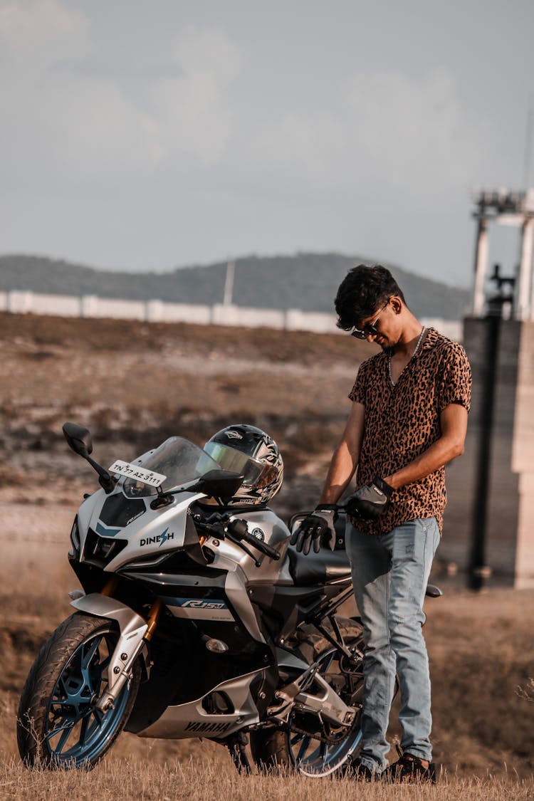 Man Standing By Sports Motorbike