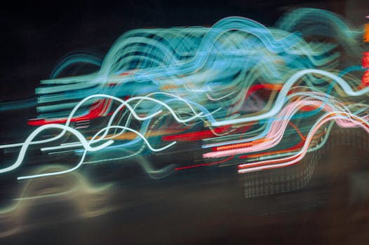 Vibrant abstract photo of dynamic neon light trails in motion, creating a colorful visual effect.