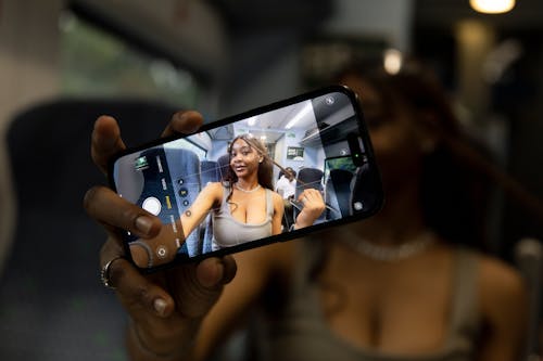 Woman Showing Selfie on Smartphone