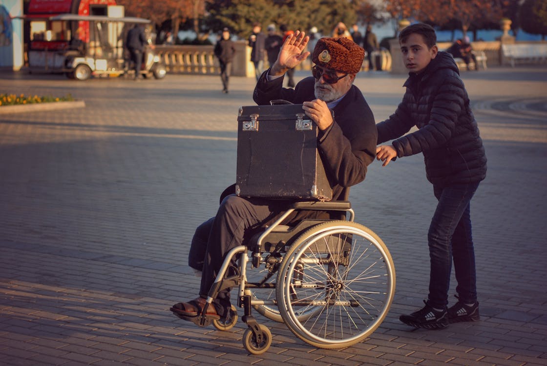 image of a young caregiver moving with an aging man