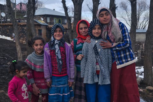 Children Standing against Village