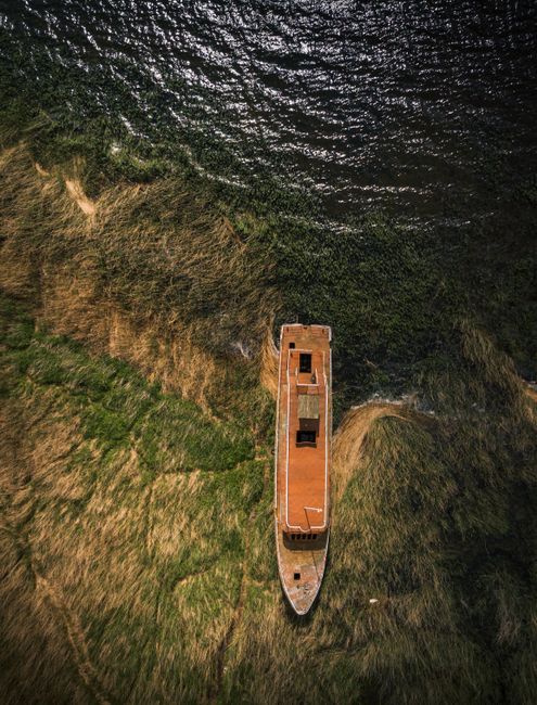 Drone capture of an old boat on the shoreline near Szczecin, Poland.