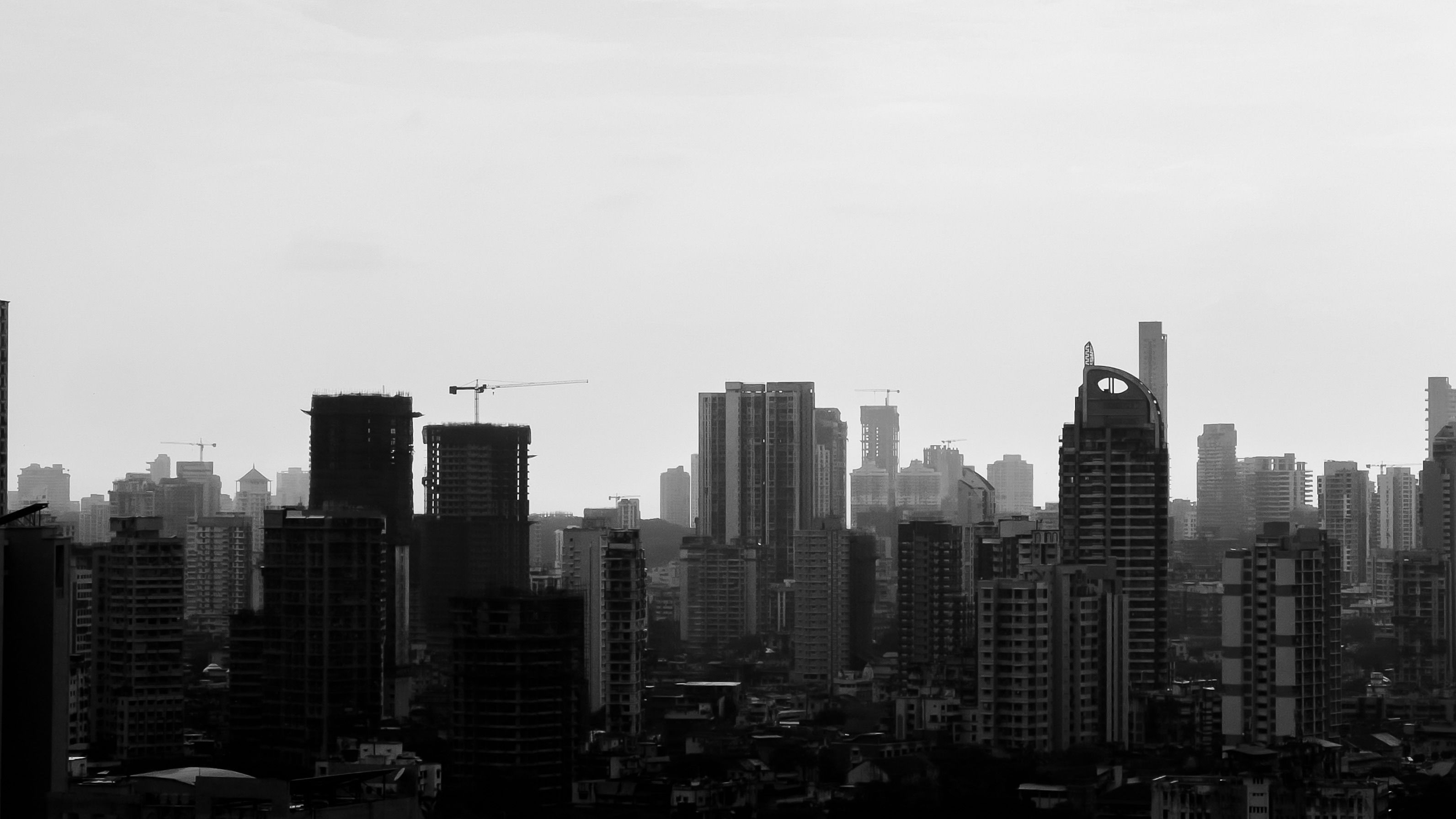 Glass office towers and old mill chimneys side by side in Lower Parel