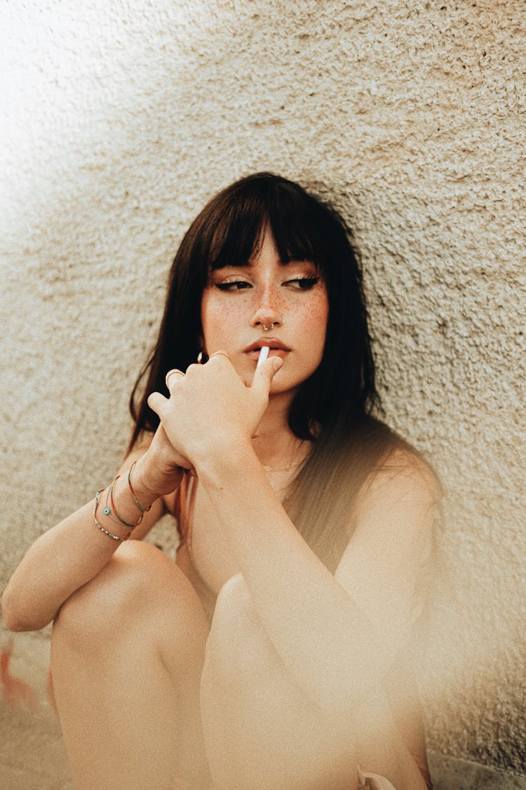 Woman Putting Cigarette In Mouth