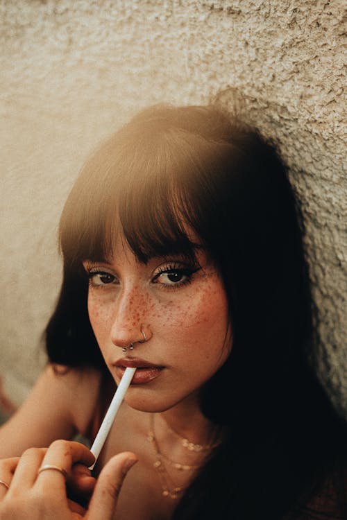 Brunette with Freckles Smoking Cigarette · Free Stock Photo